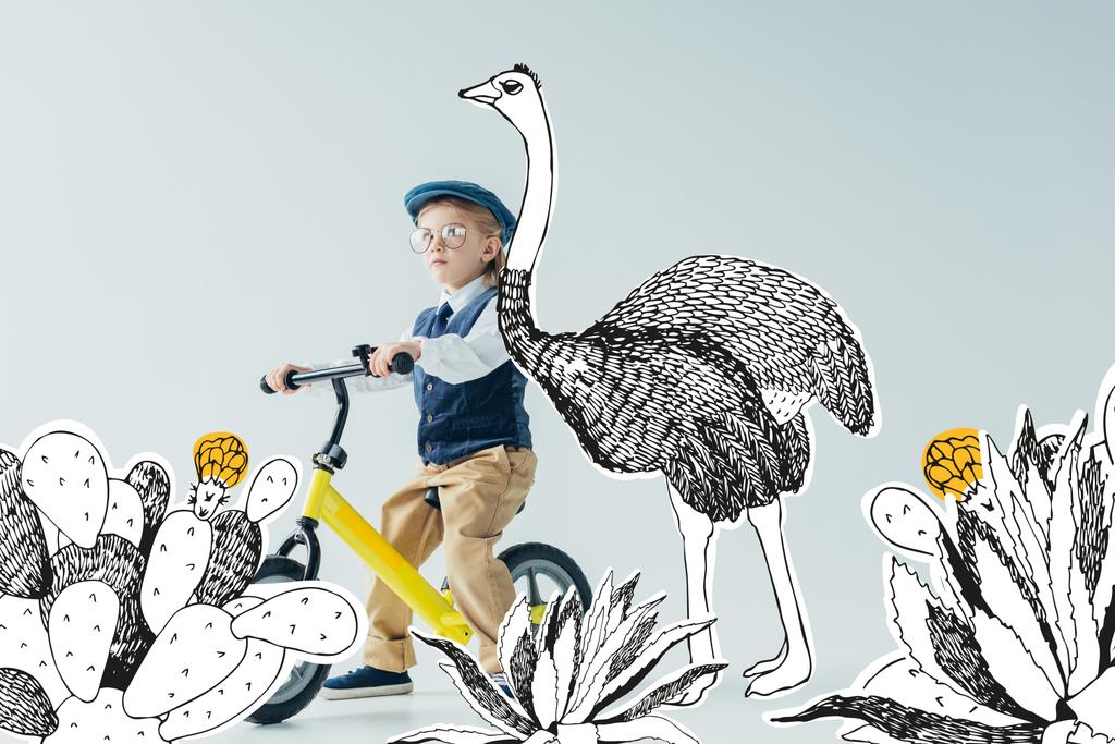 вдумчивый ребенок в ретро жилете и кепке на велосипеде на сером фоне со страусом среди кактусов иллюстрации
 - Фото, изображение