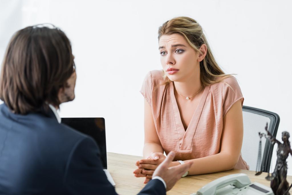 адвокат разговаривает с расстроенной женщиной, сидящей в офисе
 - Фото, изображение