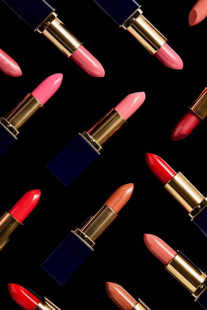 background with various shades of lipsticks isolated on black    - Photo, Image