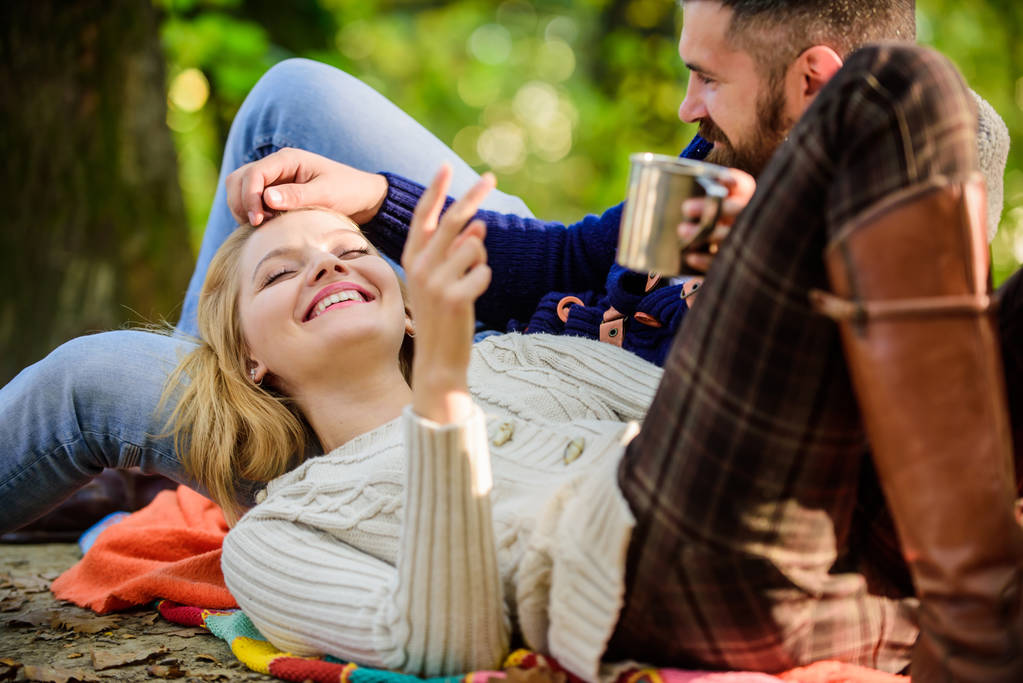 Couple in love tourists relaxing on picnic blanket. Vacation weekend picnic camping and hiking. Tourism concept. Picnic time. Happy loving couple relaxing in park together. Romantic picnic forest - Photo, Image