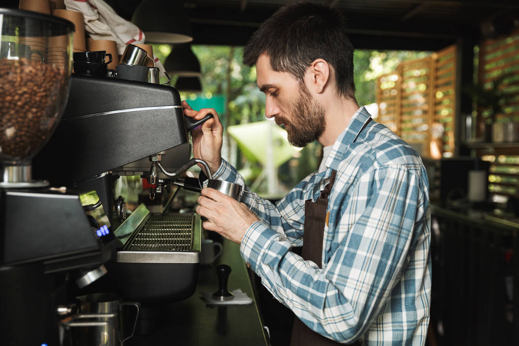 Image of professional barista man making coffee while working in - Photo, Image