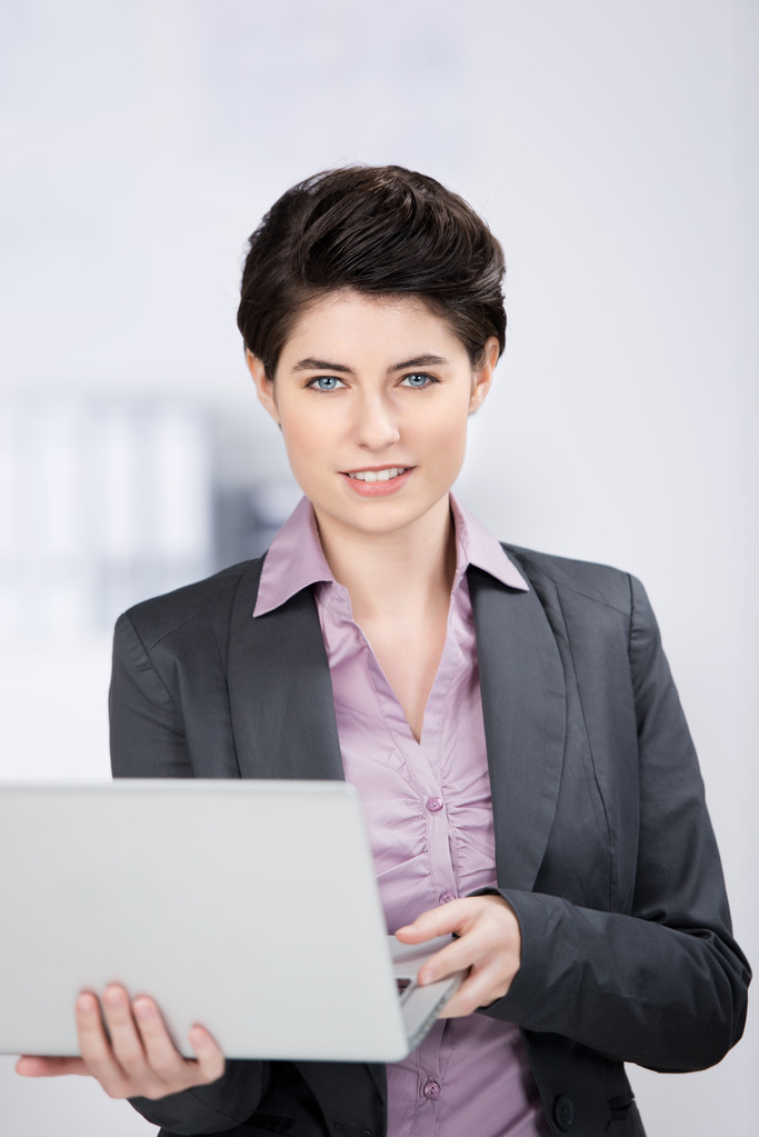 Young Businesswoman Holding Laptop In Office - Photo, Image