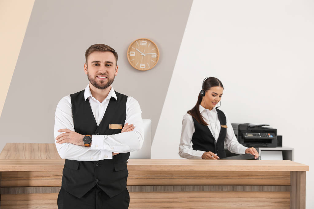 Young receptionists in professional uniform at workplace - Photo, Image