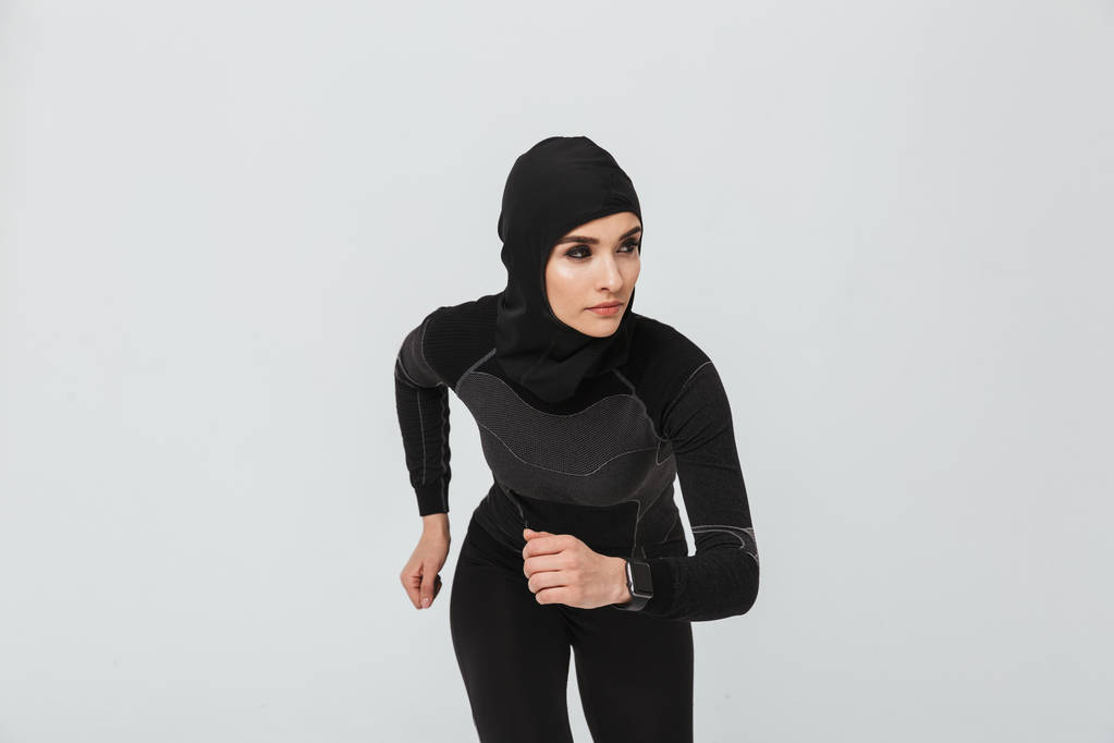 Woman fitness muslim doing exercise isolated over white wall background - Photo, Image