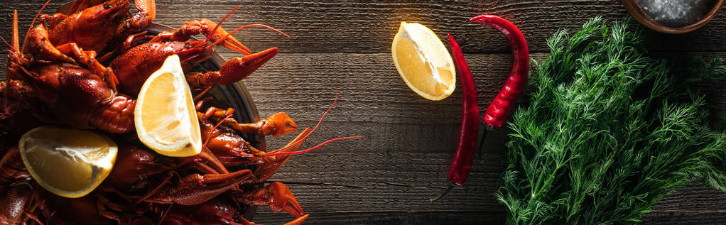 panoraama laukaus punainen hummeri, tilli, pippuri ja sitruuna viipaleita puupinnalla
 - Valokuva, kuva