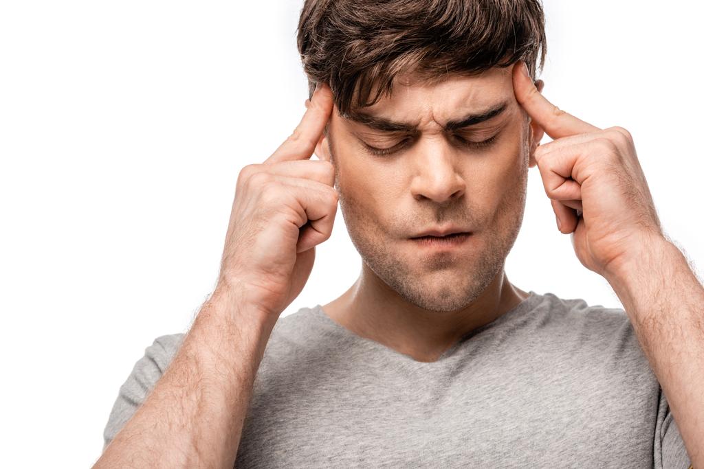 Erschöpfter Mann leidet an Migräne und berührt Kopf mit Fingern isoliert auf weiß - Foto, Bild