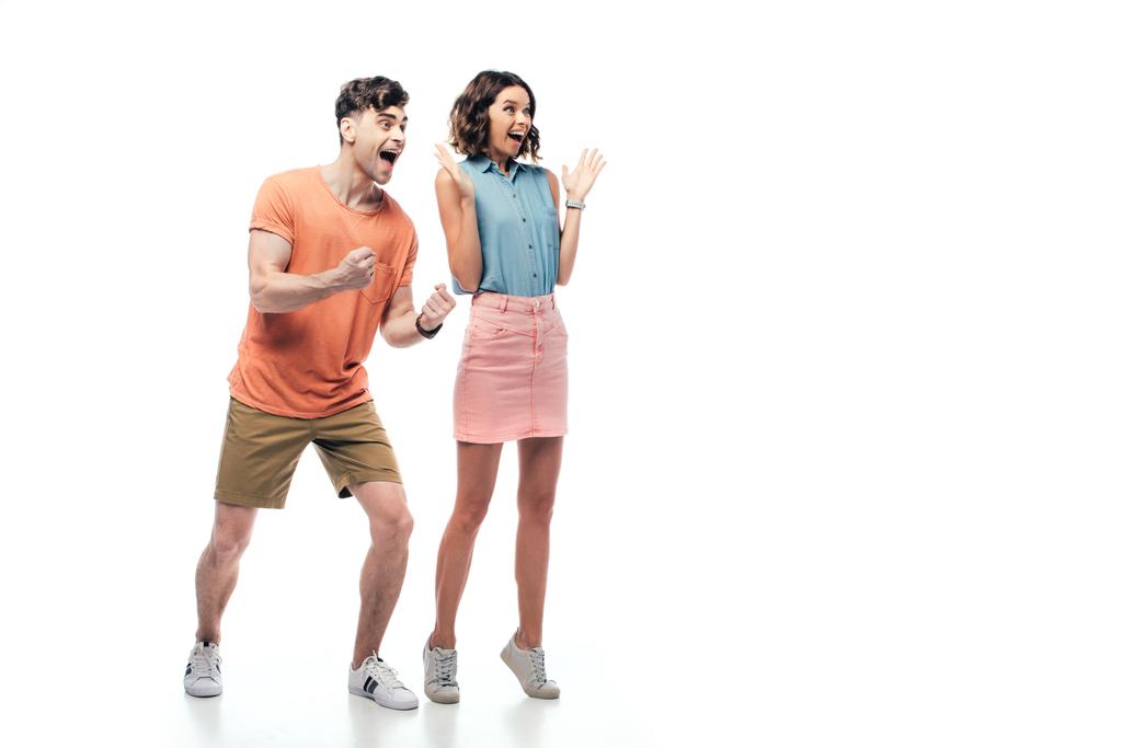 excited man and woman showing yes gestures and looking away on white background - Photo, Image