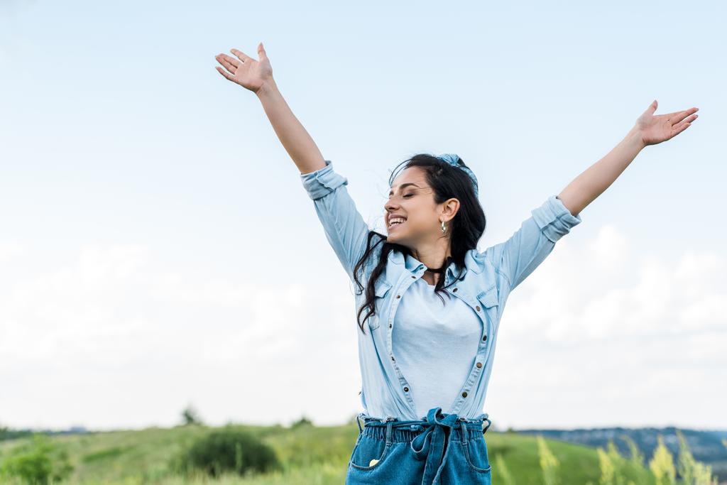 cheerful young woman with  closed eyes and outstretched hands  - Photo, Image