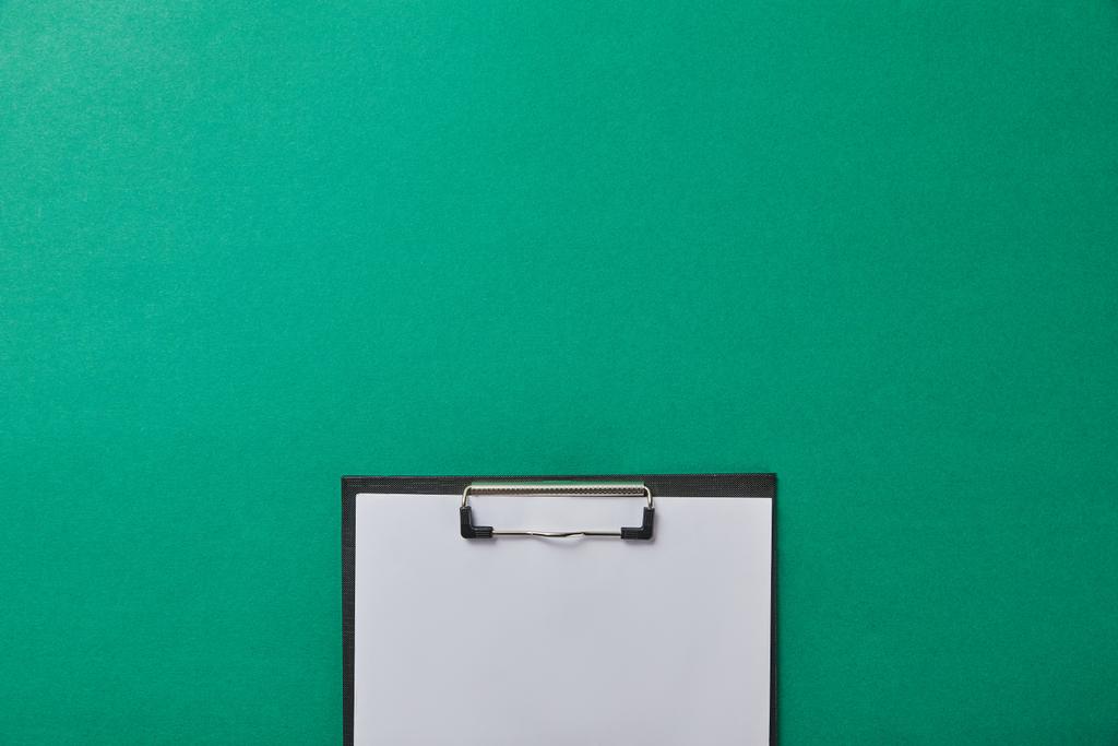 top view of folder with blank paper isolated on green isolated on green - Photo, Image