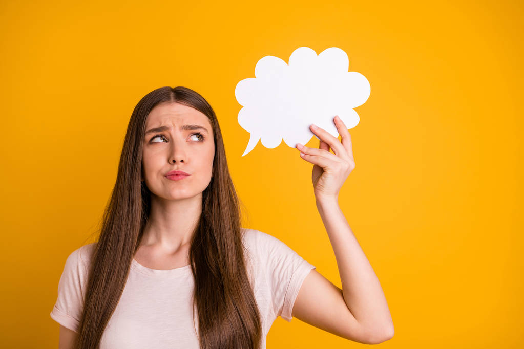 Close up photo beautiful she her lady very long hair hold hand arm paper mind cloud express not sure position situation look up ponder pensive wear casual pastel t-shirt isolated yellow background - Photo, Image
