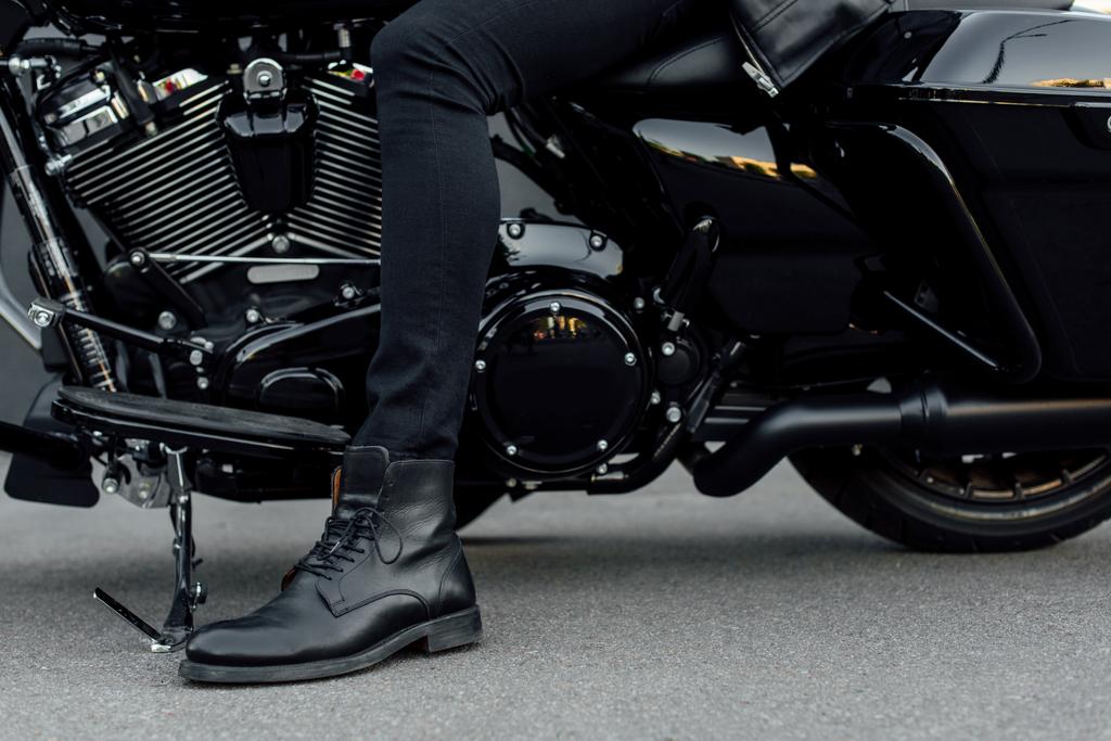 cropped view of man in black boot sitting on motorcycle - Photo, Image
