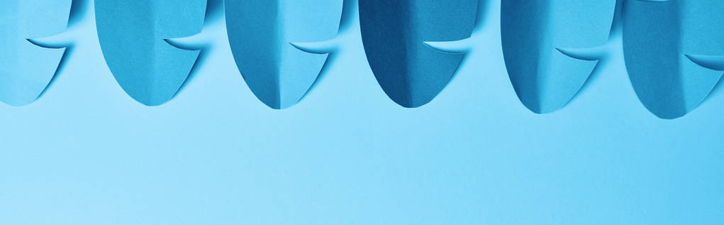 panoramic shot of blue minimalistic paper cut palm leaves on blue background with copy space - Photo, Image