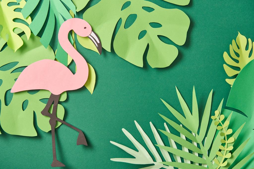 vista superior de hojas de palma cortadas en papel exótico y flamenco rosa sobre fondo verde con espacio para copiar
 - Foto, imagen
