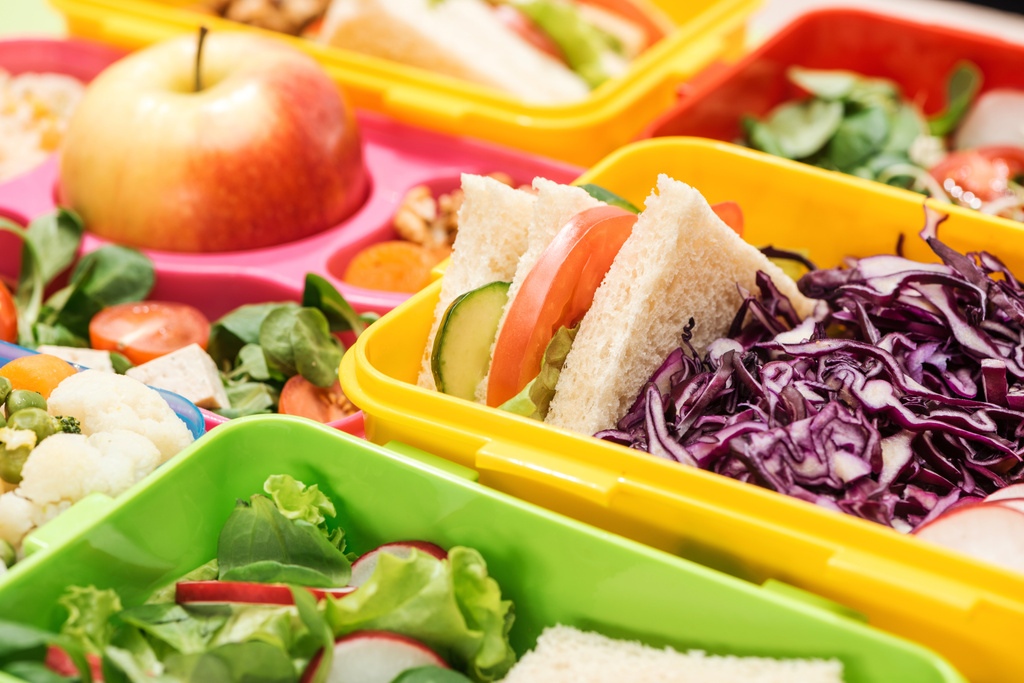 close up view of tasty food in lunch boxes - Photo, Image