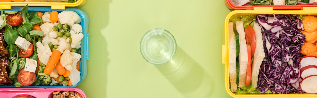 panorámaképes üveg vízzel ebéd dobozok között - Fotó, kép