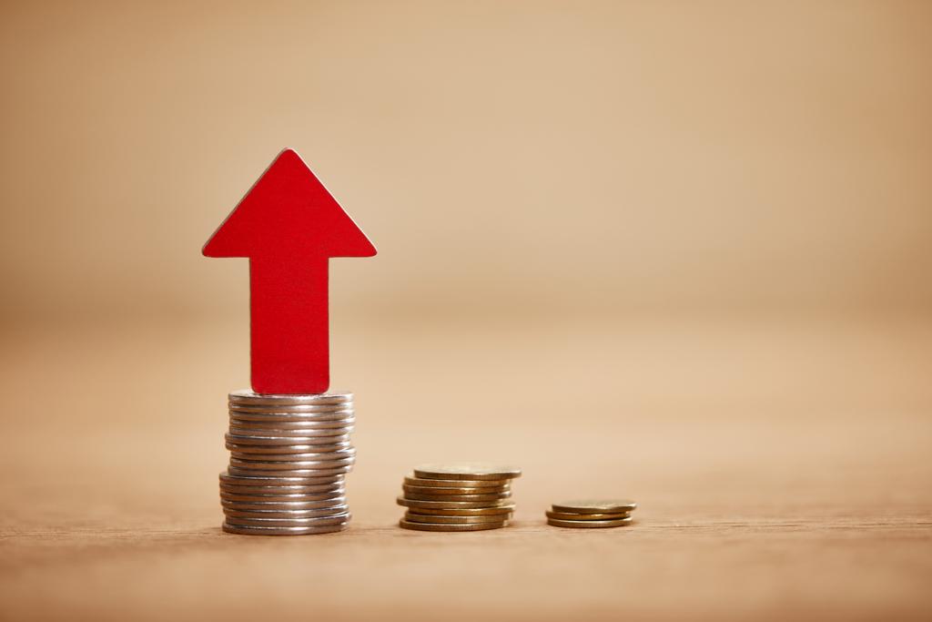 increasing chart made of coins with red arrow upwards, financial growth concept - Photo, Image