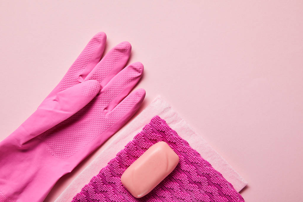top view of pink rags, rubber glove and soap on pink background  - Photo, Image