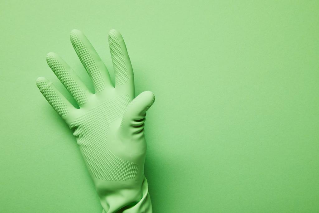 cropped view of man in rubber glove on green background  - Photo, Image