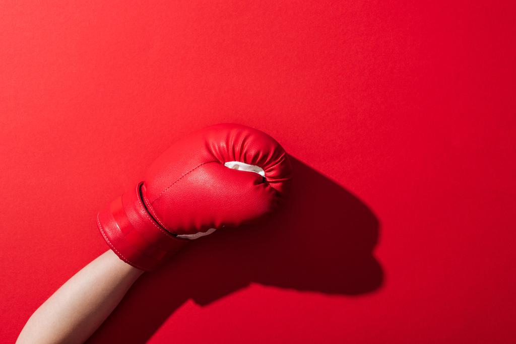 cropped view of woman in boxing glove on red  - Photo, Image