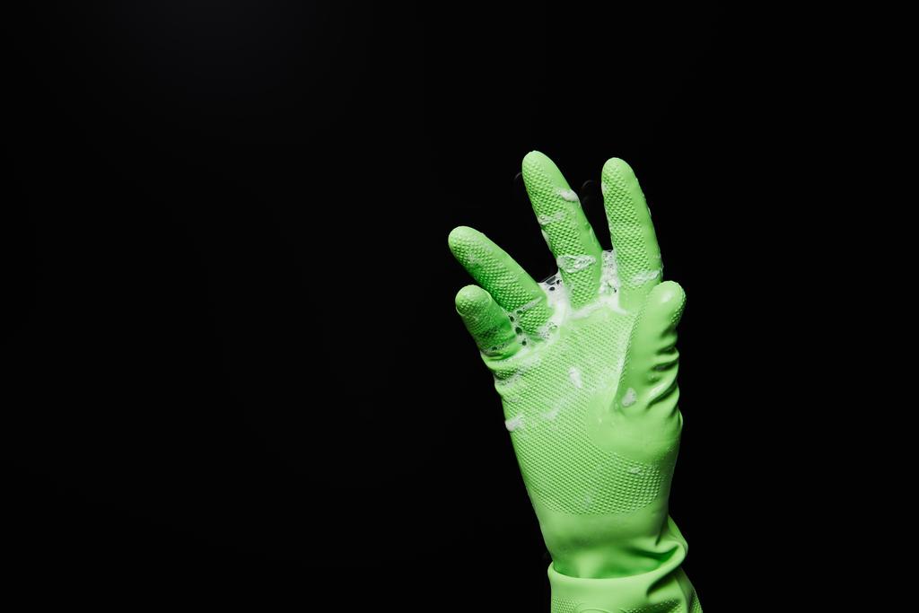 cropped view of man in rubber glove with foam isolated on black - Photo, Image