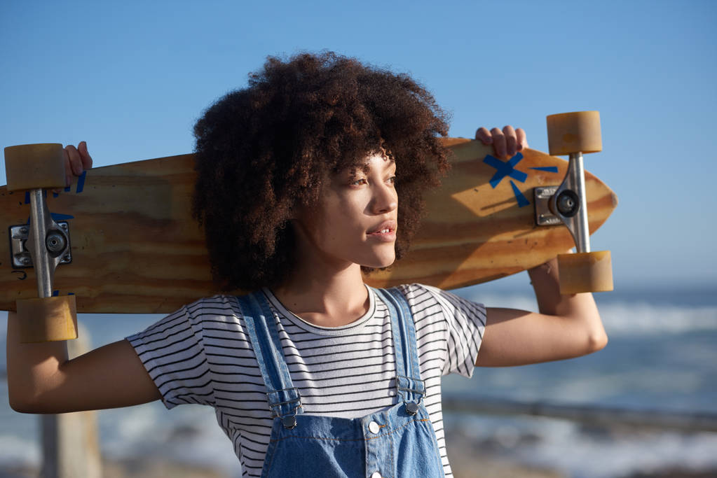 Free spirit girl holding long board  - Photo, Image