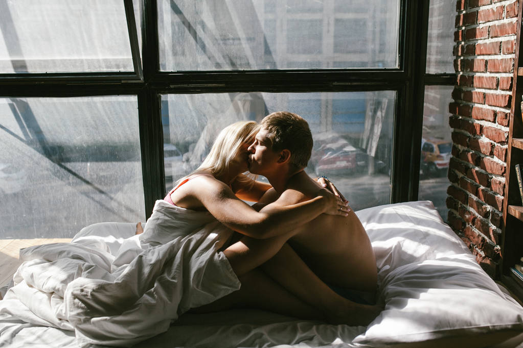 young couple in love posing in bedroom - Photo, Image