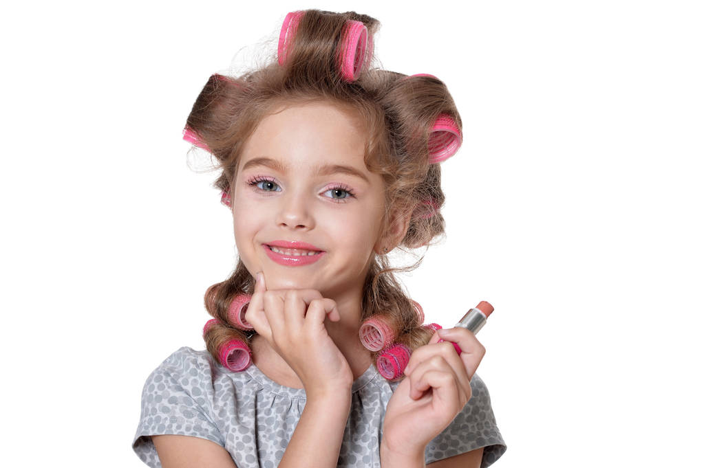 portrait of  little pretty girl with hair curlers with lipstick  isolated on white background - Photo, Image