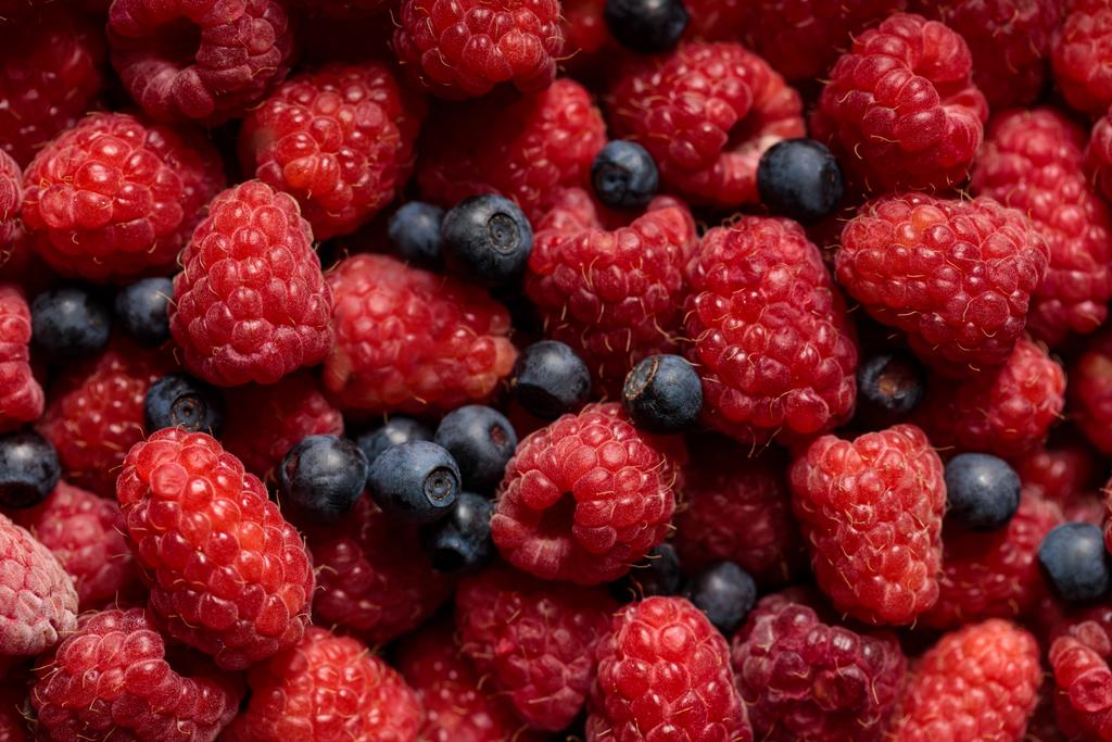 close up view of fresh delicious ripe mixed raspberries and blueberries  - Photo, Image