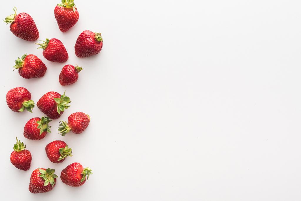 Draufsicht auf süße und rote Erdbeeren auf weißem Hintergrund  - Foto, Bild
