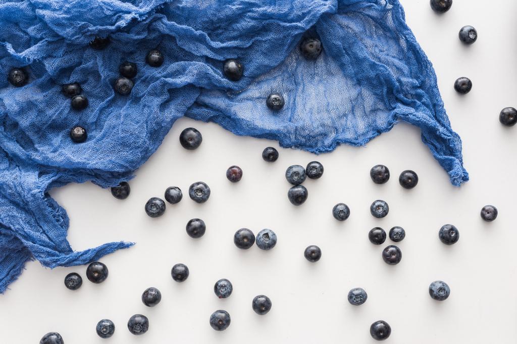 vista superior de mirtilos doces e inteiros em pano azul
  - Foto, Imagem