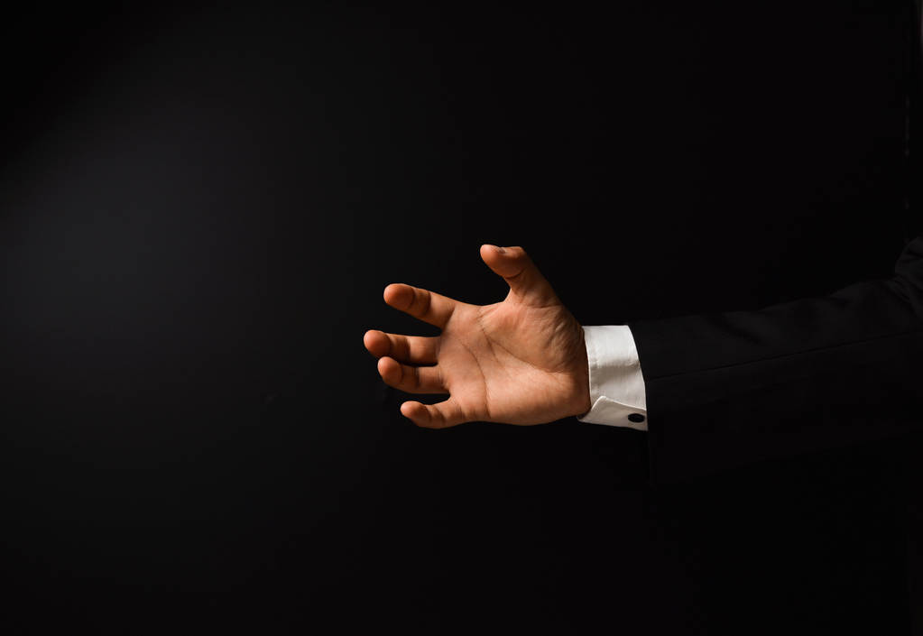 Geschäftsmann die Hand auf schwarzem Hintergrund - Foto, Bild