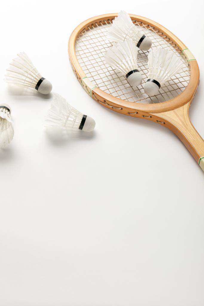 close up view of wooden badminton racket and shuttlecocks on white background with copy space - Photo, Image