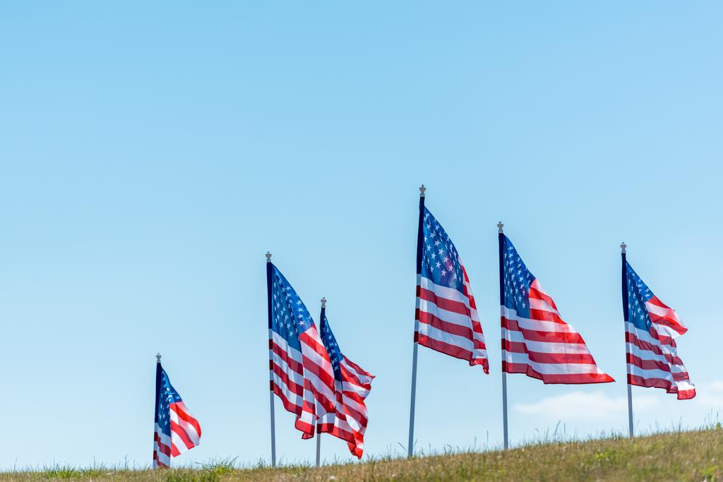 national american flags on green grass against blue sky  - Photo, Image