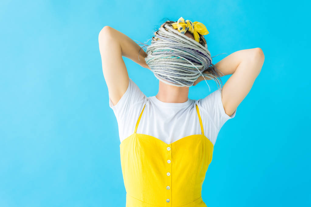 дівчина з дредлоками, що покривають обличчя волоссям ізольовані на бірюзовому
 - Фото, зображення