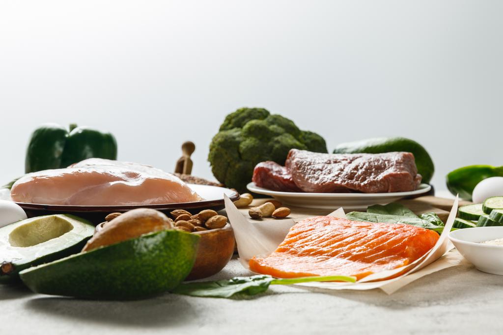 φρέσκο ωμό σολομό, κρέας και στήθος κοτόπουλου κοντά σε πράσινα λαχανικά απομονωμένα σε γκρι, Κετογενική δίαιτα μενού - Φωτογραφία, εικόνα