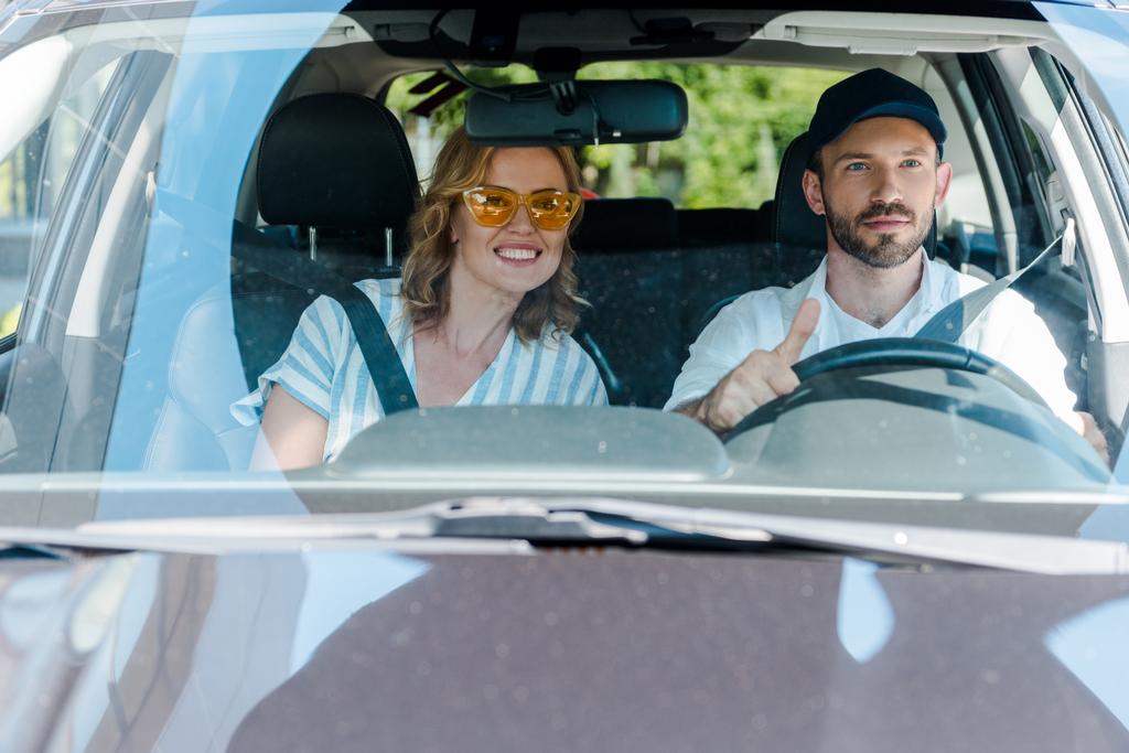 selective focus of man driving car near attractive woman  - Photo, Image