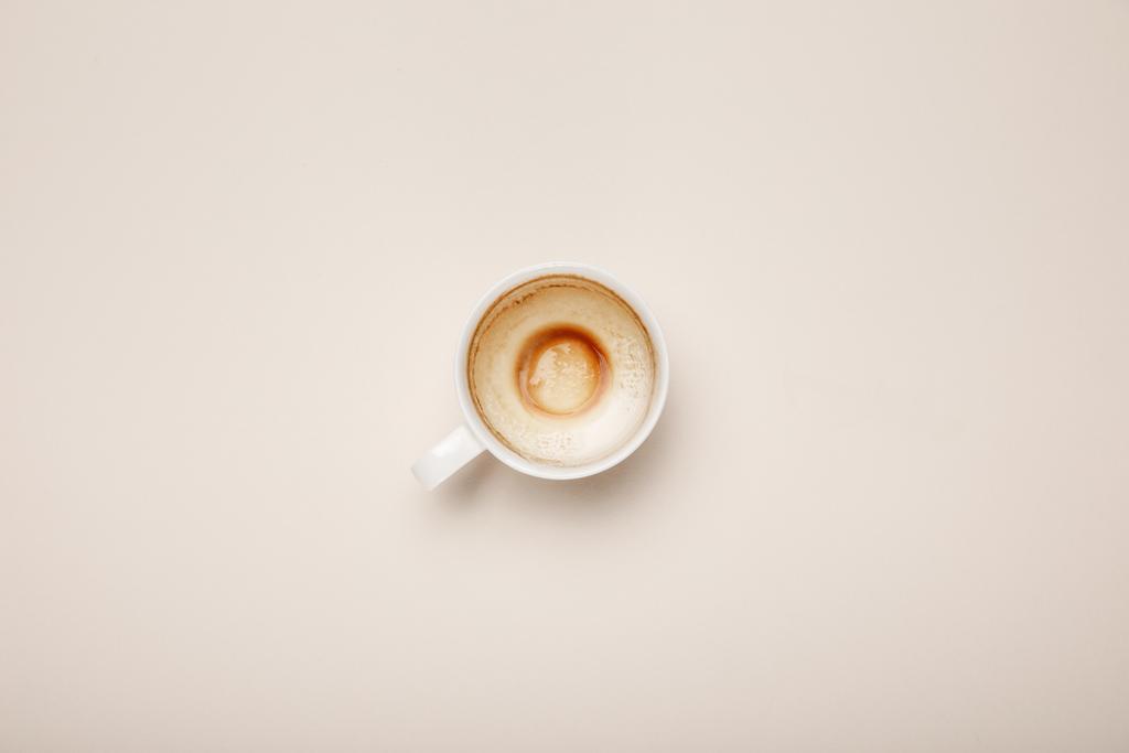 top view of coffee cup with foam on beige background - Photo, Image