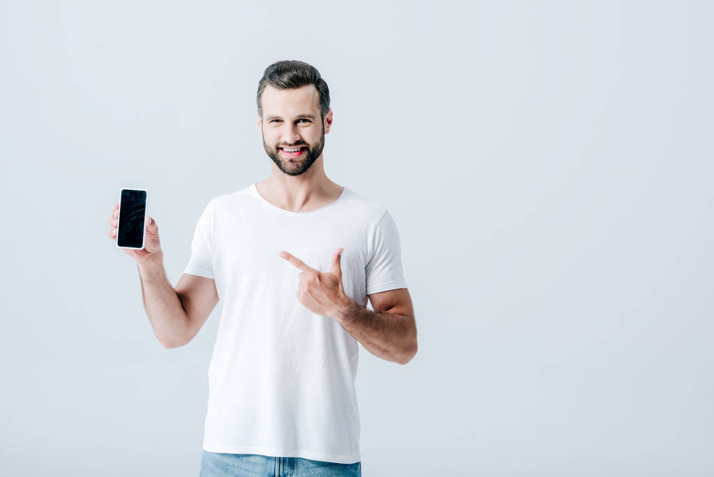 man pointing with finger at smartphone with blank screen isolated on grey - Photo, Image