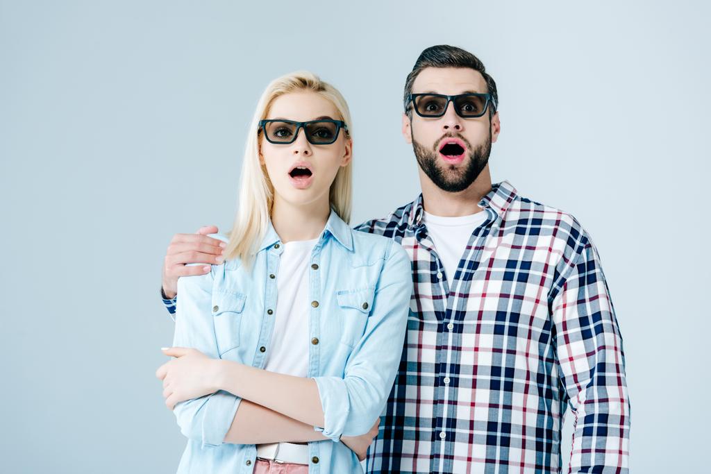 шокований чоловік і дівчина дивиться фільм в 3d окулярах ізольовані на сірому
 - Фото, зображення