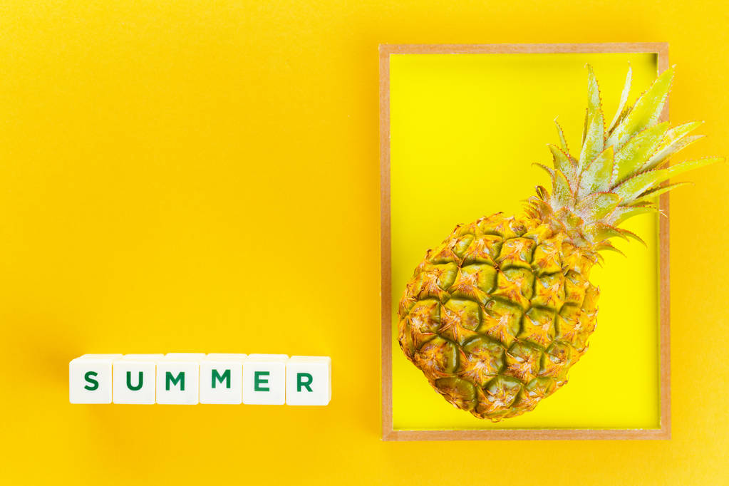 pineapple in a frame on summer yellow background - Photo, Image