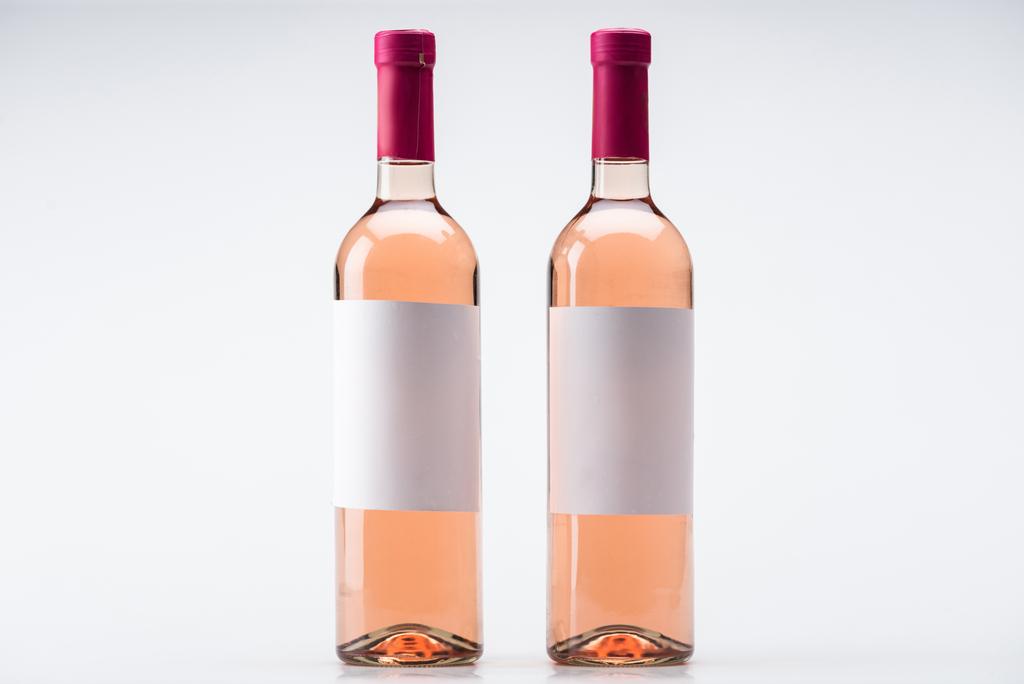 bottles of rose wine with blank labels on white background - Photo, Image