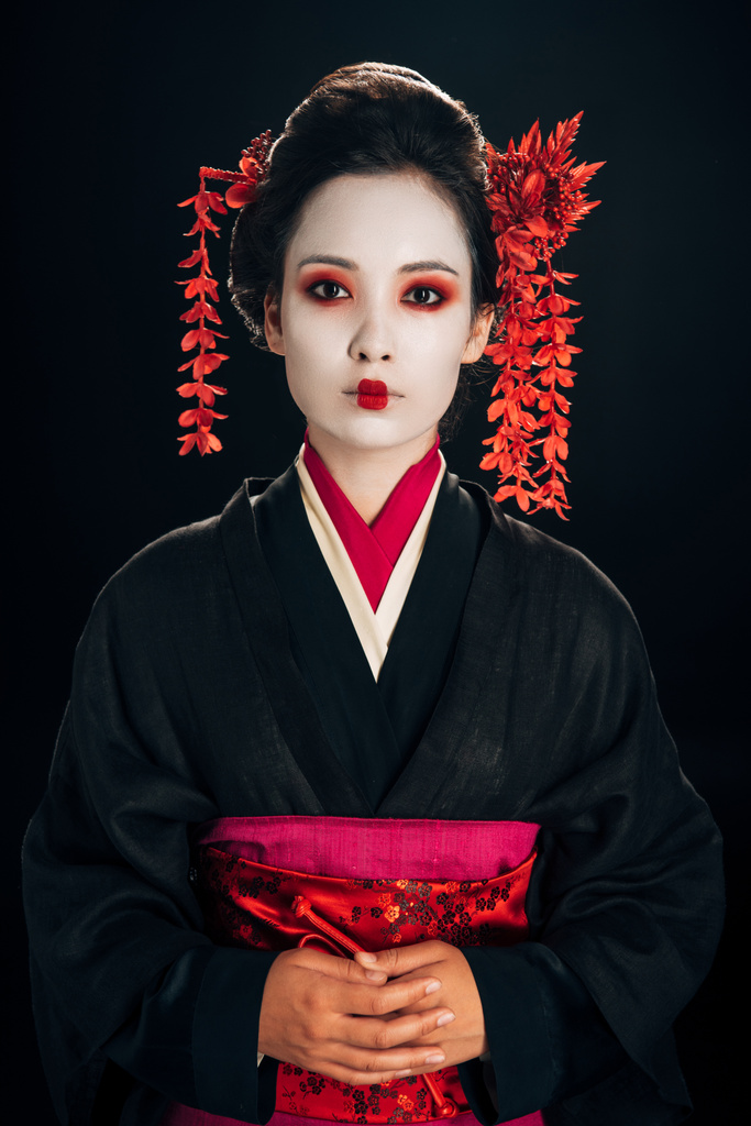 kaunis geisha musta ja punainen kimono ja kukkia hiukset eristetty musta
 - Valokuva, kuva