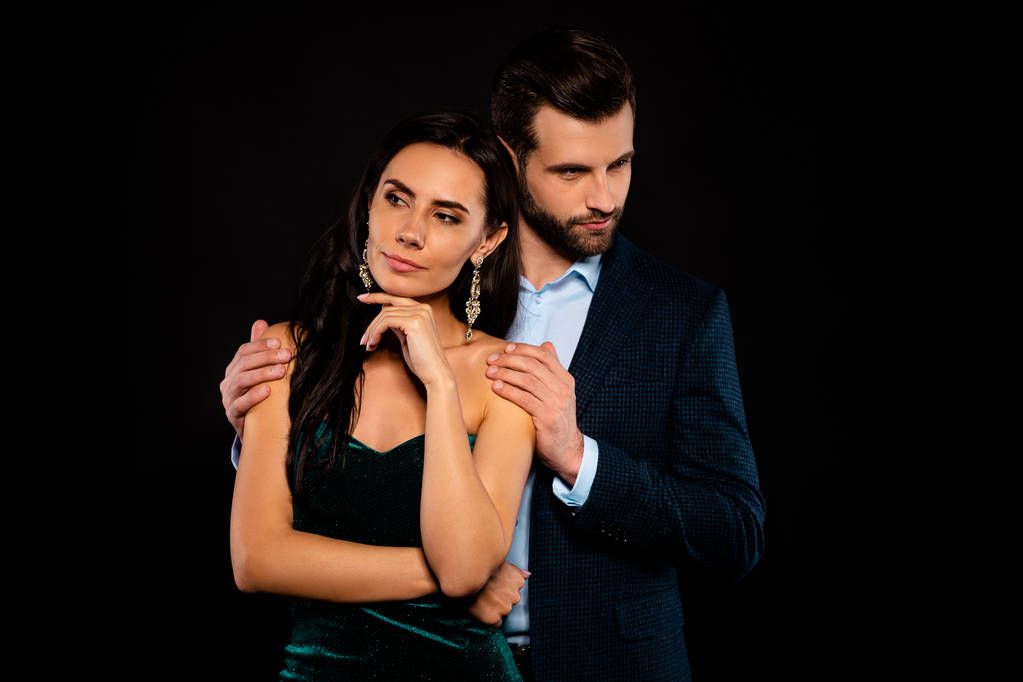 Close up photo rich pair classy she her chic hand arm fingers chin he him his hold shoulders look side piggyback pose wear blue plaid costume jacket velvet green dress isolated black background - Photo, Image