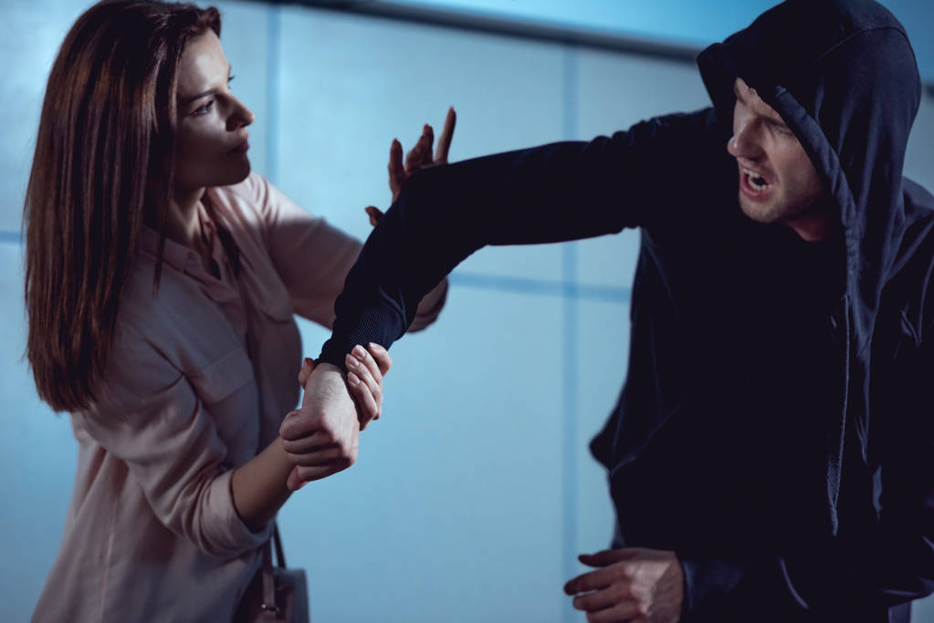beautiful woman fighting with thief in underpass - Photo, Image