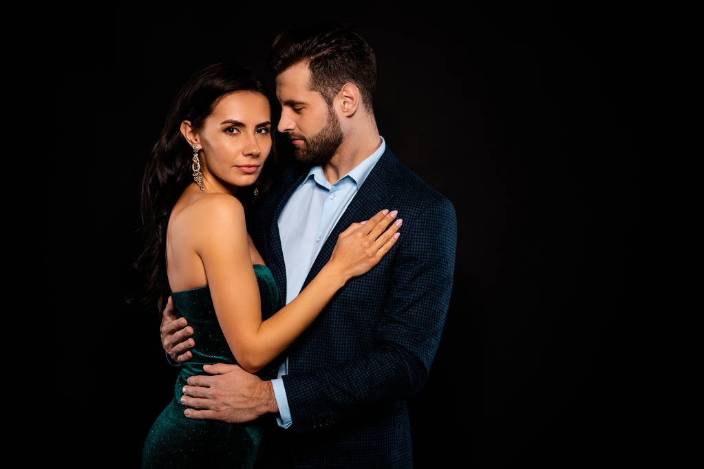 Close up side profile photo beautiful she her wife bride he him his husband fiance mrs mr married spouse protect hands slim waist hold close wear costume jacket green dress isolated black background - Photo, Image