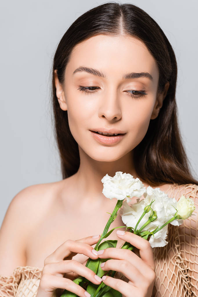 tender beautiful brunette woman with white carnations isolated on grey - Photo, Image