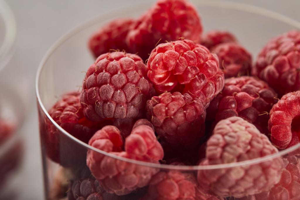 close up view of fresh tasty raspberries in glass - Photo, Image