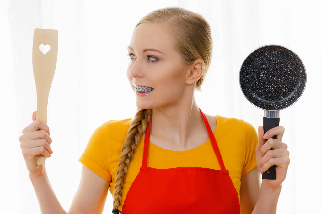 Woman holding cooking pan and spatula - Photo, Image