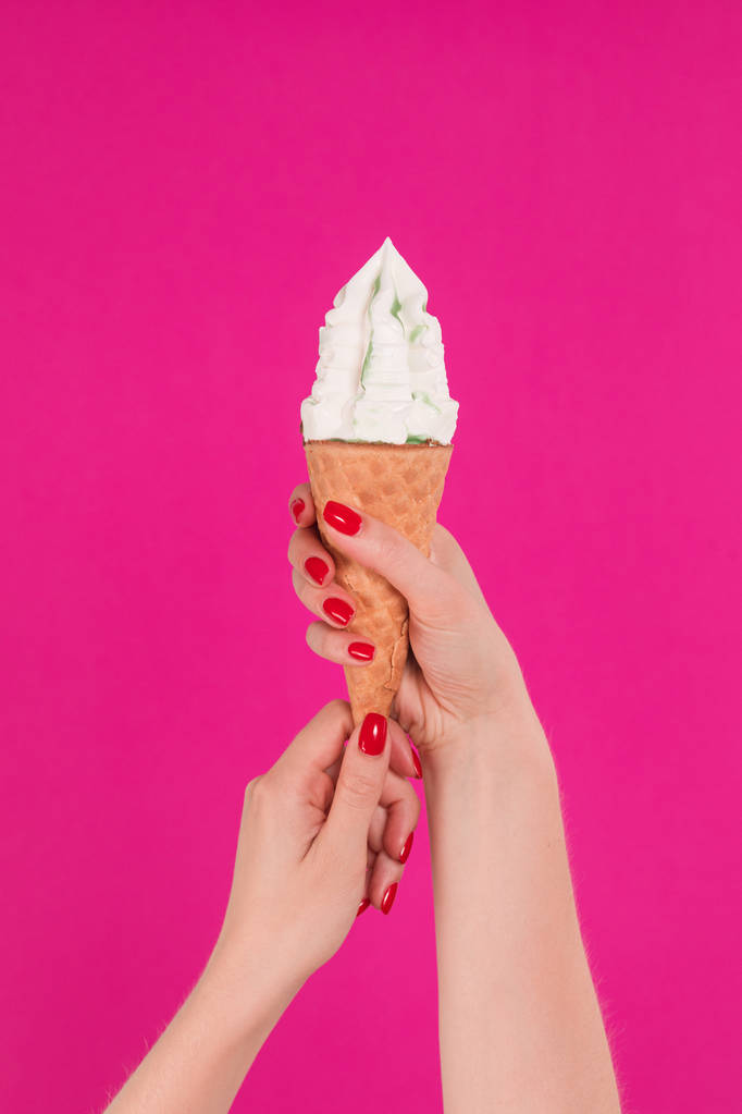 Female hand holding ice cream in waffle cone - Photo, Image