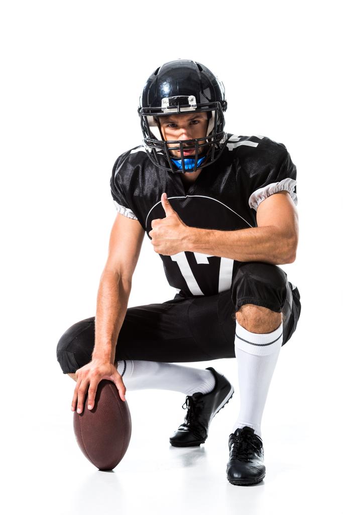 Amerikai futball játékos labdát csinál hüvelykujj megjelöl jel-ra fehér - Fotó, kép